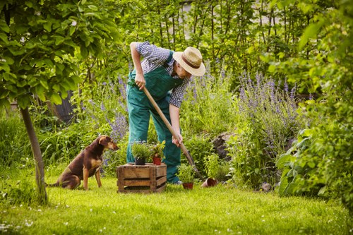 Worker using protective equipment during landscaping tasks