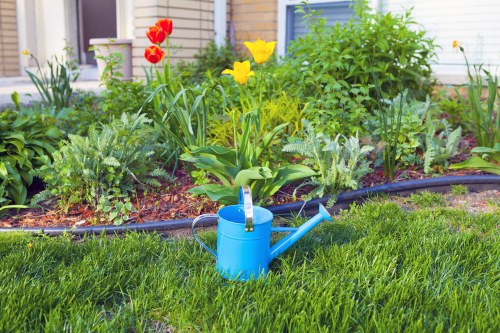 Worker carrying out landscaping services with tools and garden materials